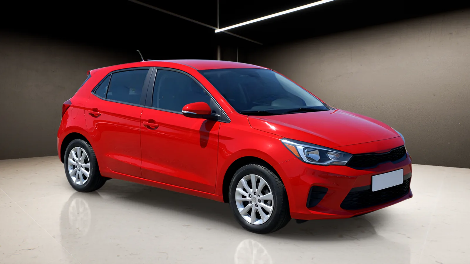 The same photograph from the console: the hatchback in a dark studio with light strips, a reflective floor and a soft shadow.
