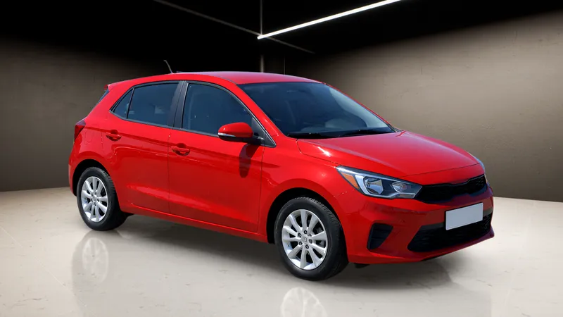 The same hatchback from the console, in a dark studio with light strips and a reflective floor.