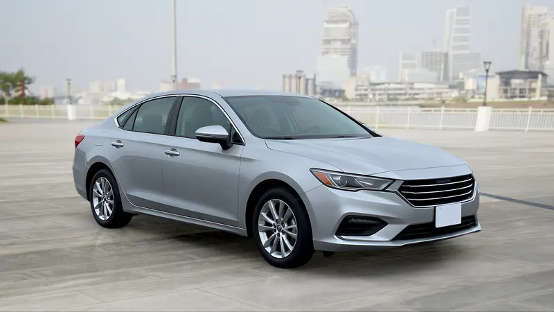 The same sedan on a city waterfront.